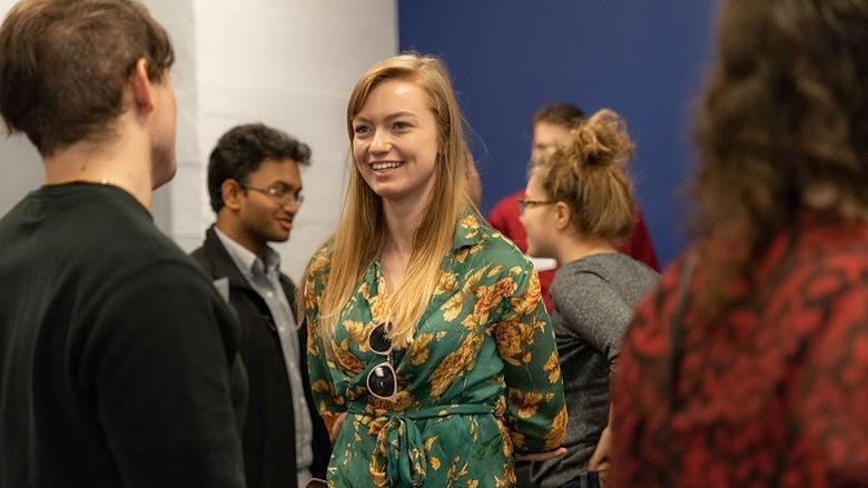 Female student speaks to another student